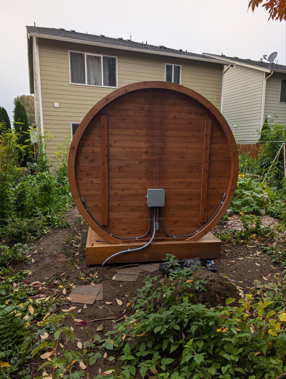 Outdoor sauna with visible electrical connection