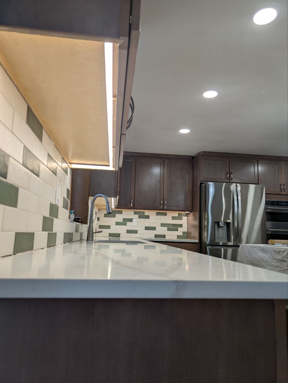 Kitchen with undercabinet lighting and recessed ceiling lights