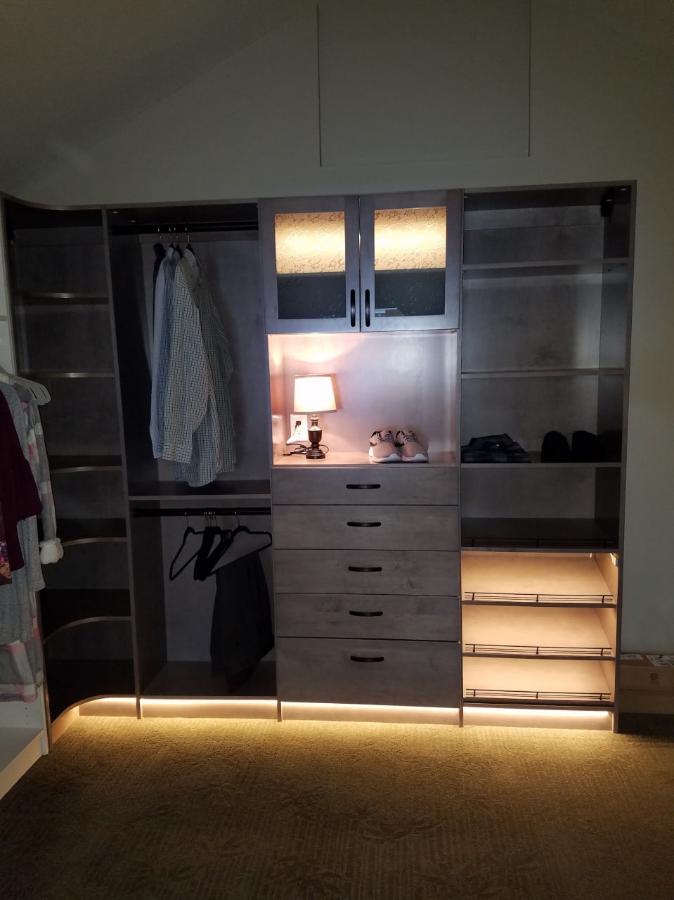 Closet with shelf and cabinet lighting details